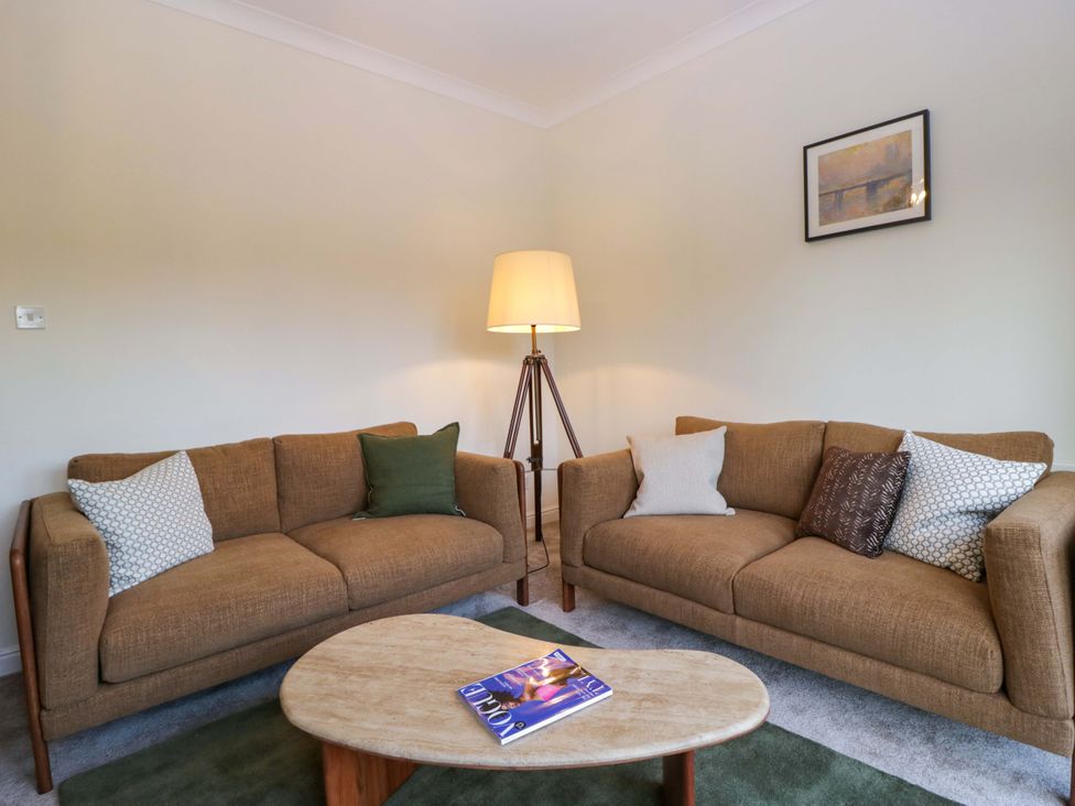 A living room with a sofa and coffee table at 11 Tram Lane in Kirkby Lonsdale