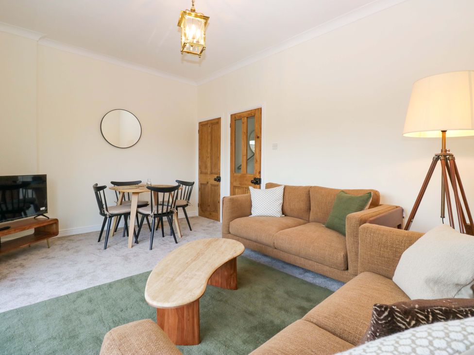A living room with a sofa and coffee table at 11 Tram Lane in Kirkby Lonsdale