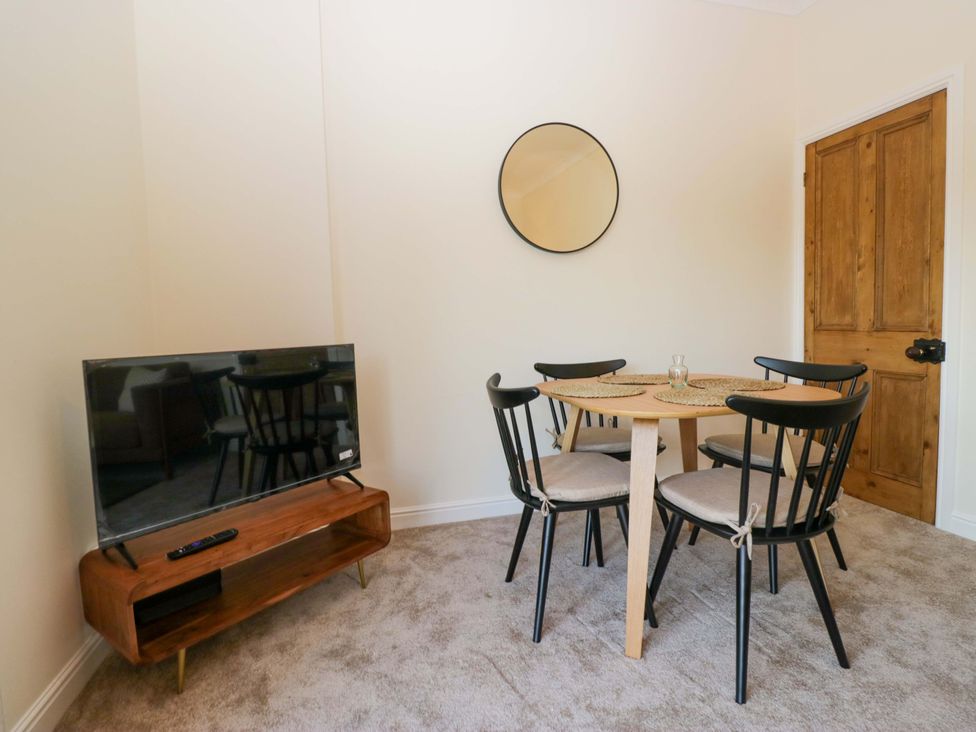 A dining room with a table and chairs at 11 Tram Lane Kirkby Lonsdale