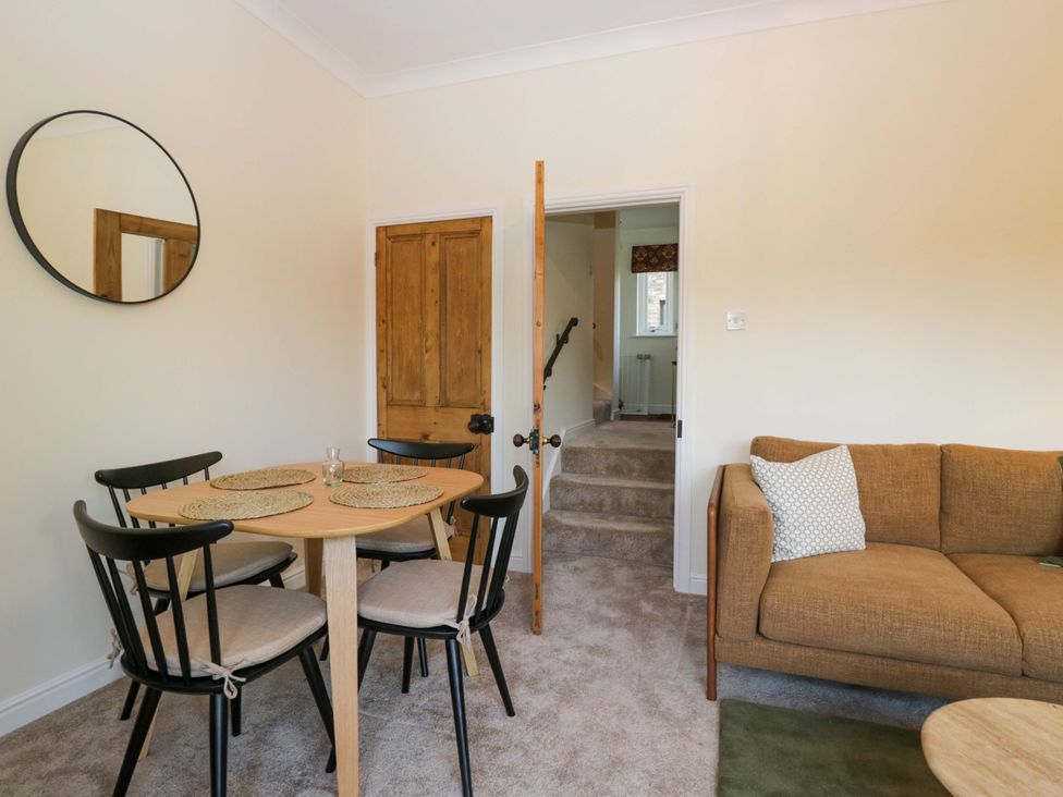 A dining room with a table and chairs at 11 Tram Lane Kirkby Lonsdale