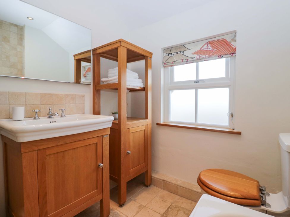 A bathroom with sink, toilet, and towel rack at 11 Tram Lane in Kirkby Lonsdale