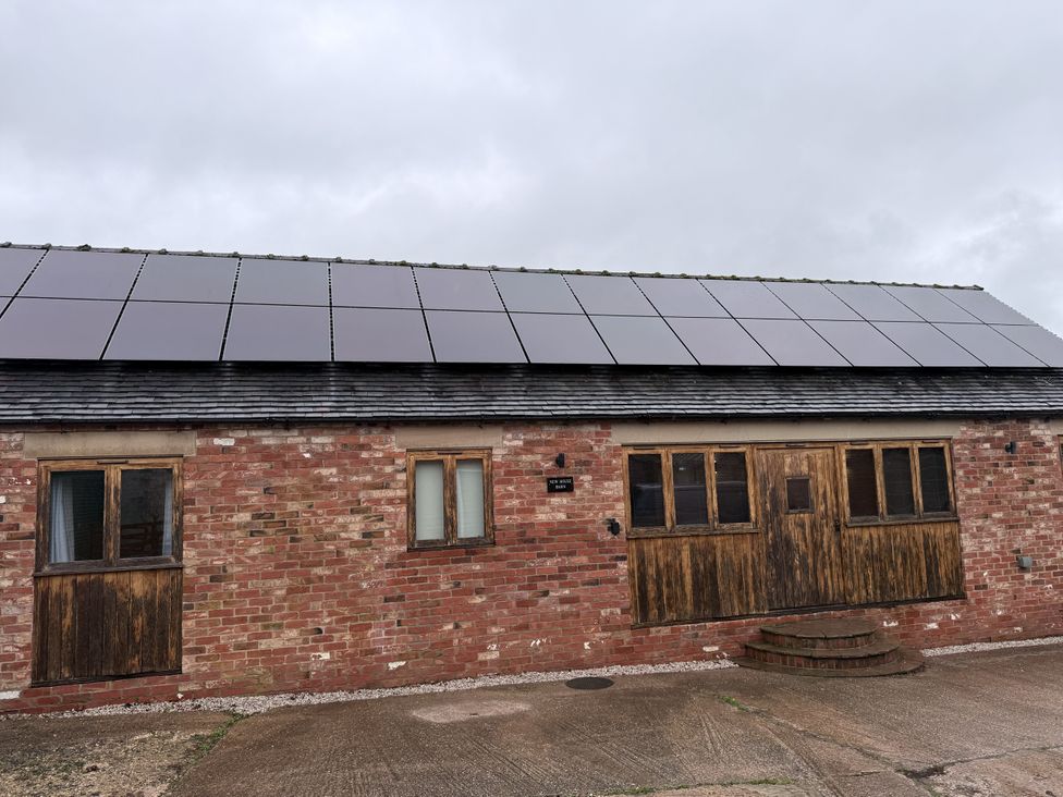 A barn with solar panels on the roof at New House Barn Ashbourne