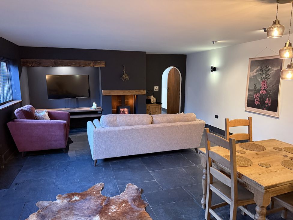 A living room with a tv and seating at New House Barn in Ashbourne