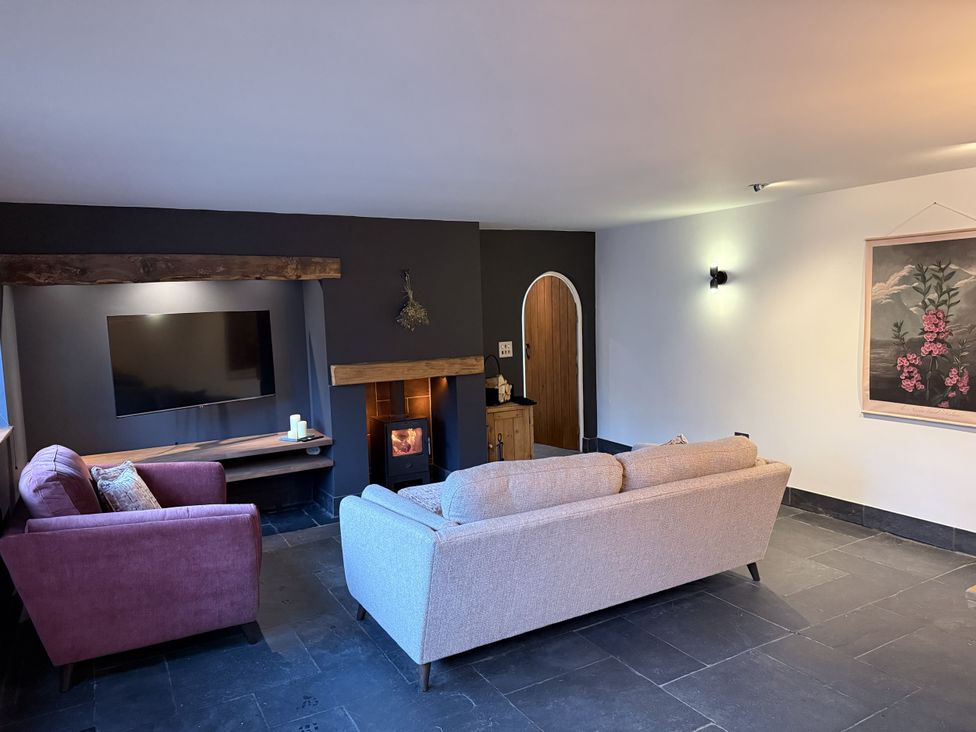 A living room with sofas and a television at New House Barn in Ashbourne