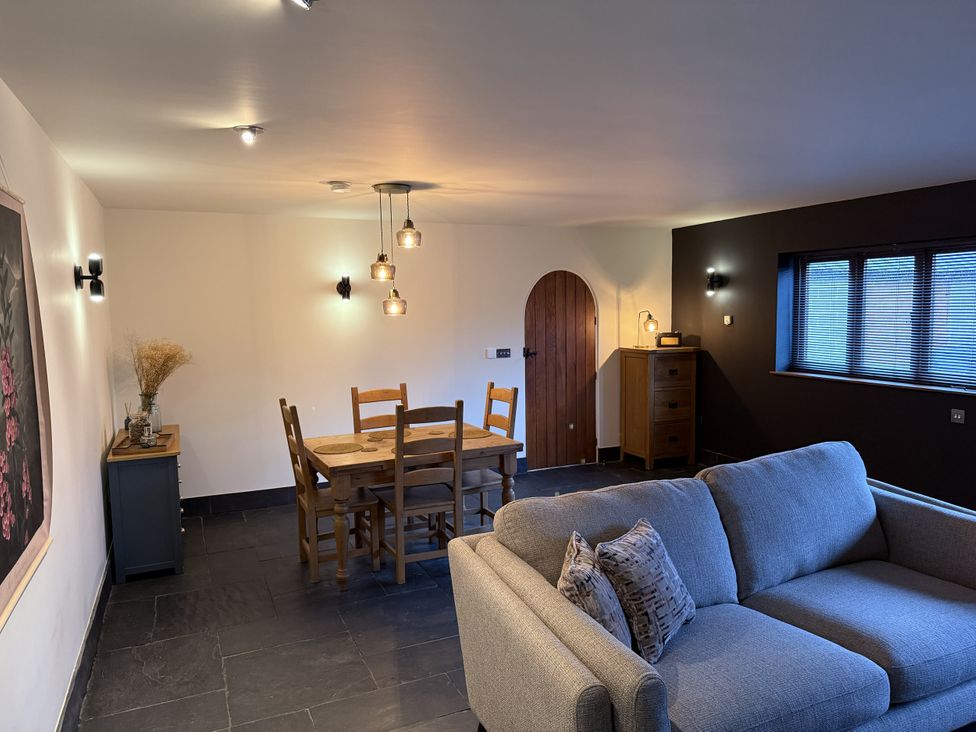 A dining room with a table and chairs at New House Barn in Ashbourne