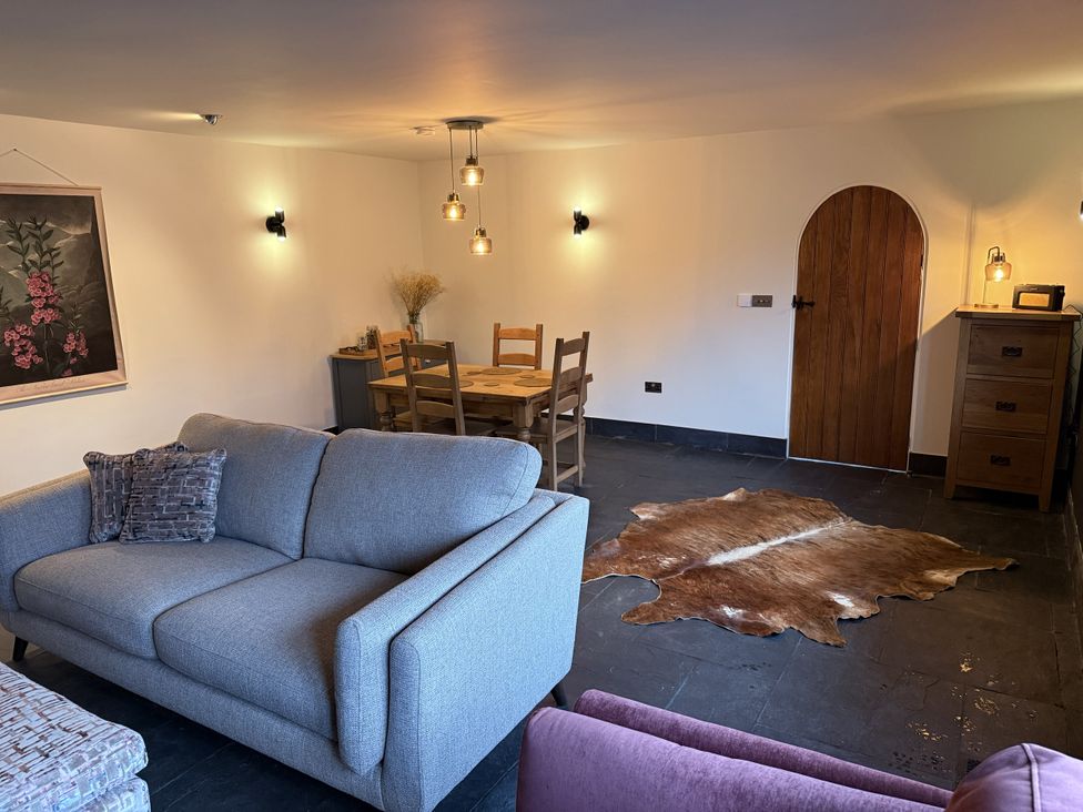 A snug with a sofa and dining table at New House Barn in Ashbourne