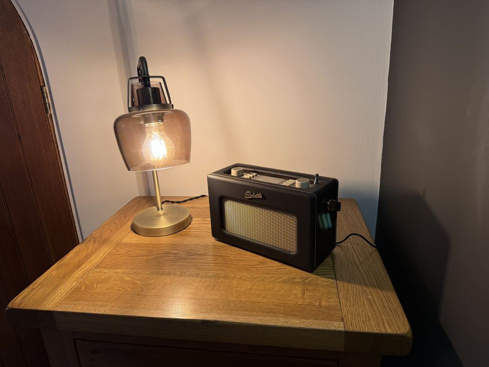 A lamp and radio on a table at New House Barn Ashbourne