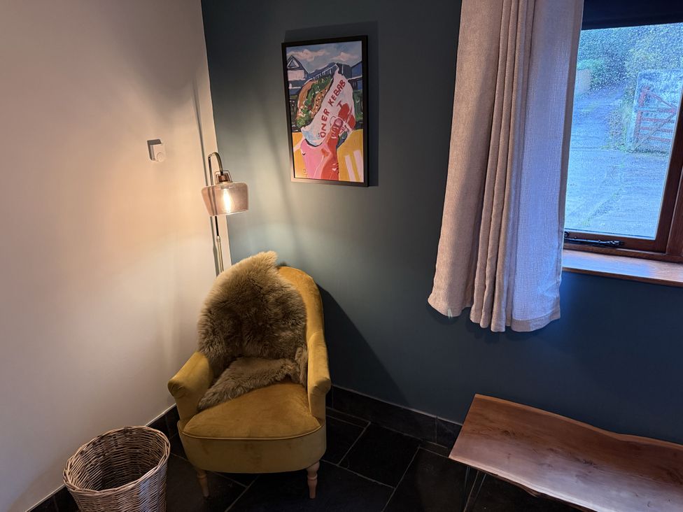 A snug with a chair and lamp at New House Barn in Ashbourne