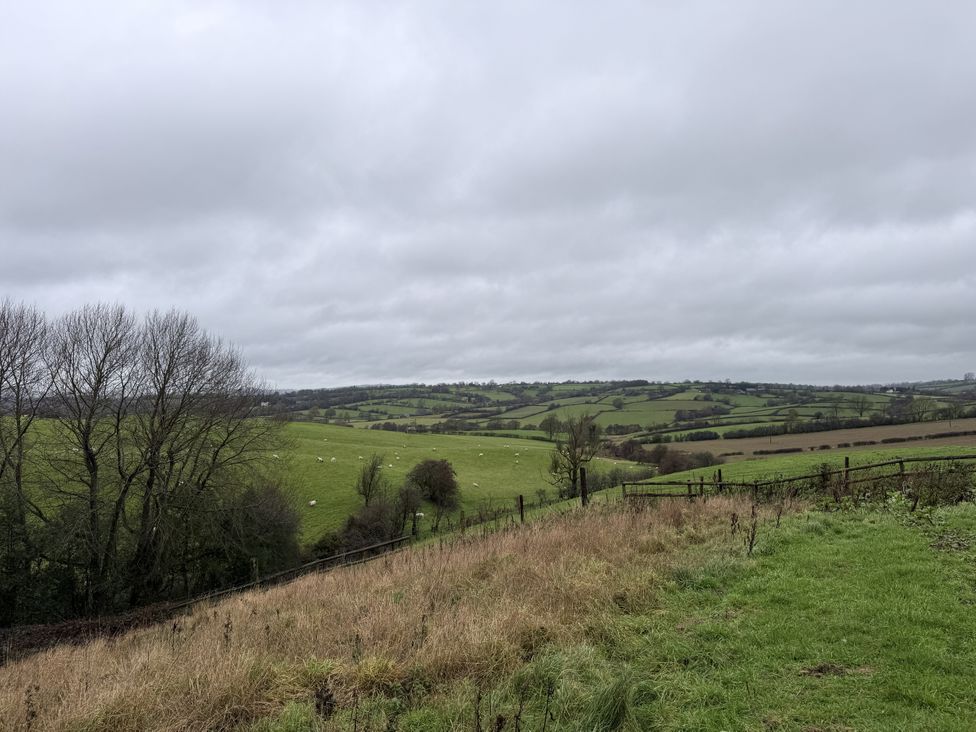 A rural landscape with hills and trees at New House Barn Ashbourne