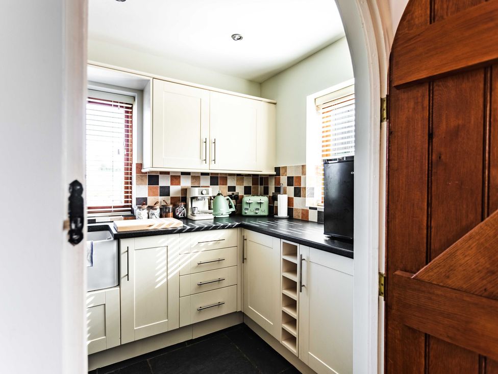 A kitchen with cabinets, sink, and appliances at New House Barn in Bradley near Ashbourne