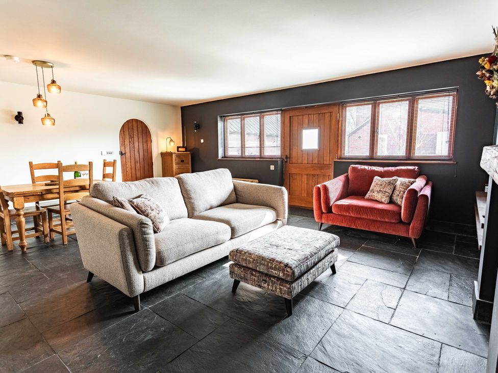 A living room with a sofa and dining table at New House Barn Bradley near Ashbourne