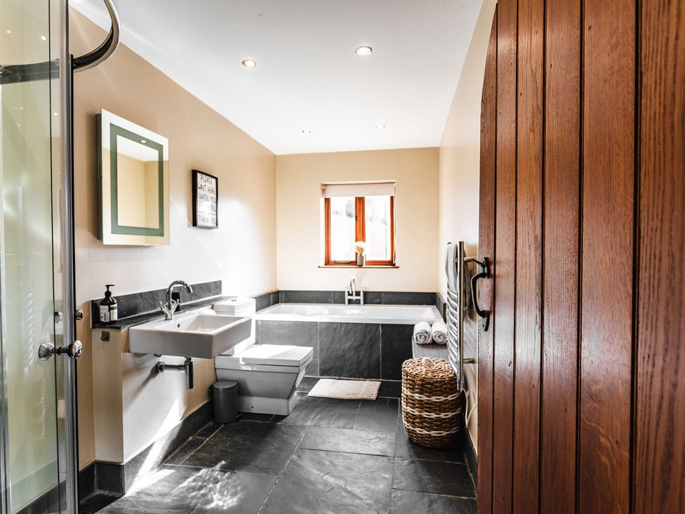 A bathroom with a sink and bathtub at New House Barn Bradley near Ashbourne