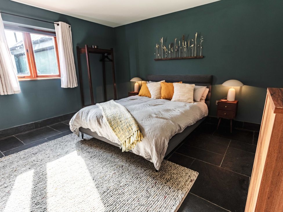 A bedroom with a bed and window at New House Barn in Bradley near Ashbourne