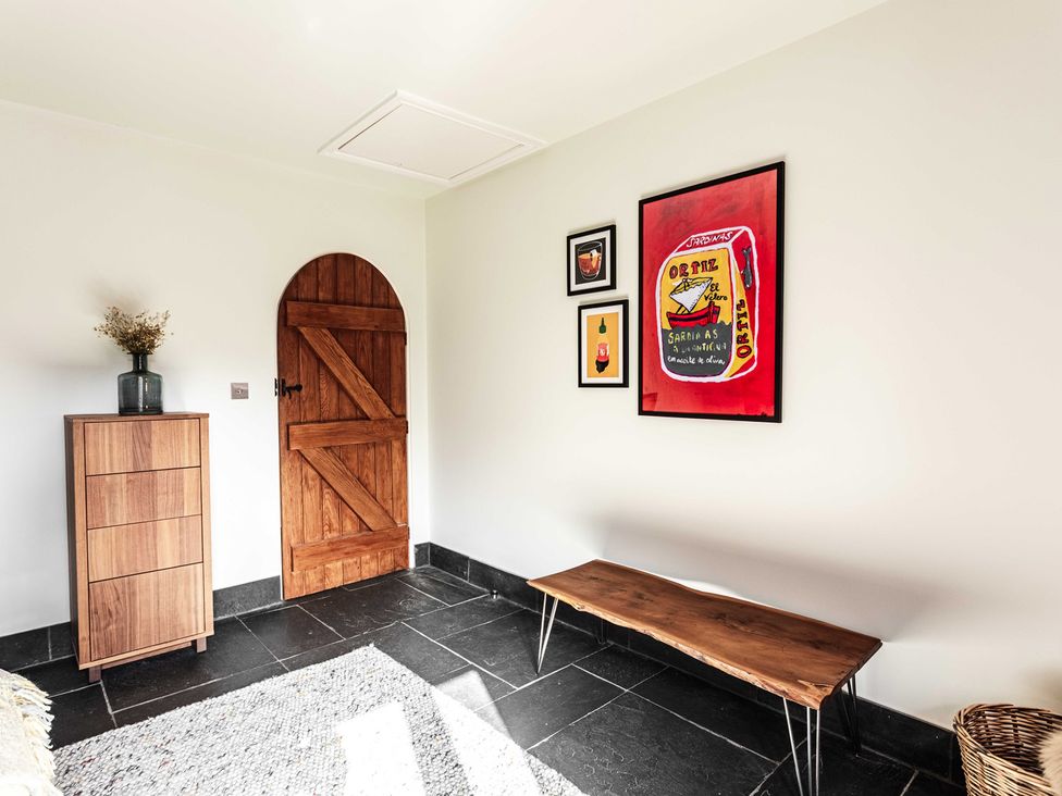 A room with a wooden door and a table at New House Barn Bradley near Ashbourne