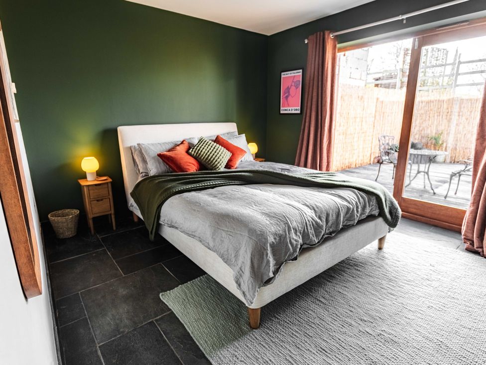 A bedroom with a bed and nightstand at New House Barn in Bradley near Ashbourne
