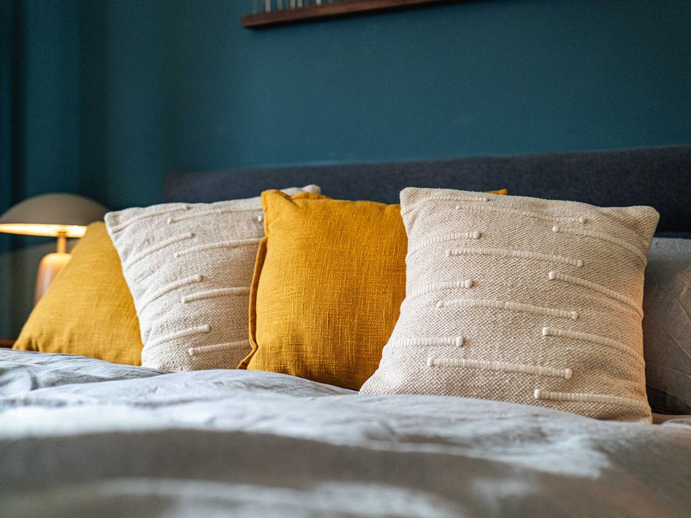 A bed with pillows and a lamp at New House Barn Bradley near Ashbourne