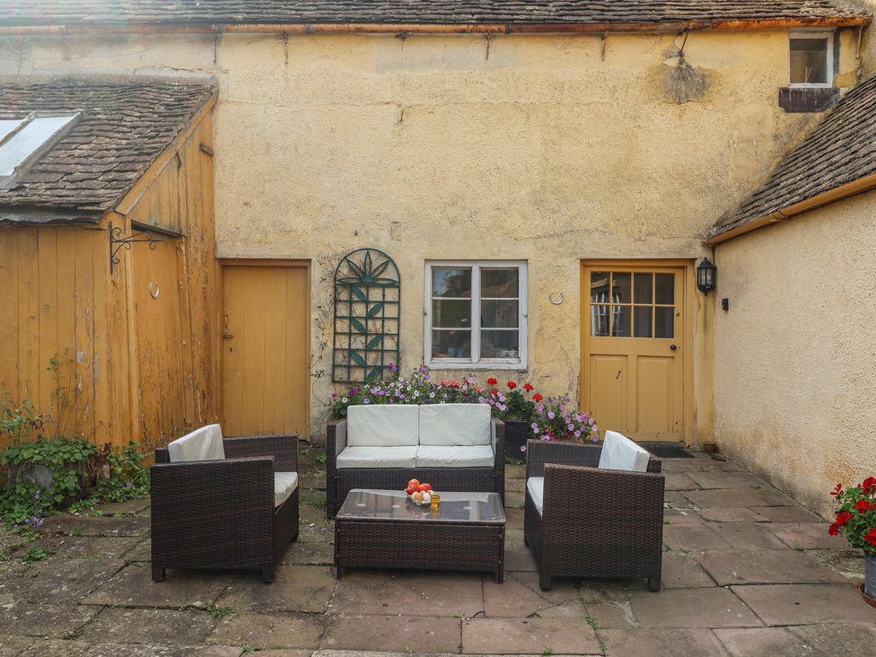 A garden area with seating and plants at The Old Dairy Acton Turville near Nettleton