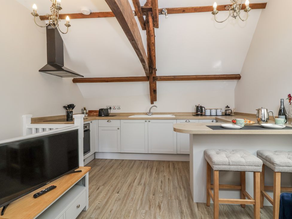 A kitchen with cabinets and appliances at The Old Dairy near Nettleton