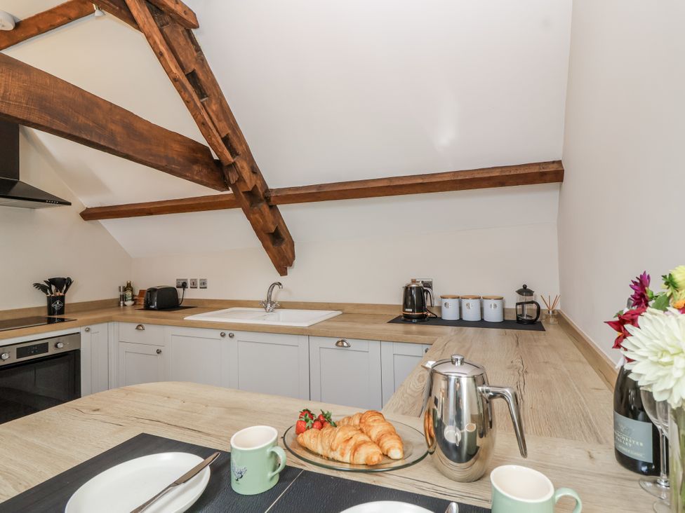 A kitchen with sink and cooking appliances at The Old Dairy Acton Turville near Nettleton