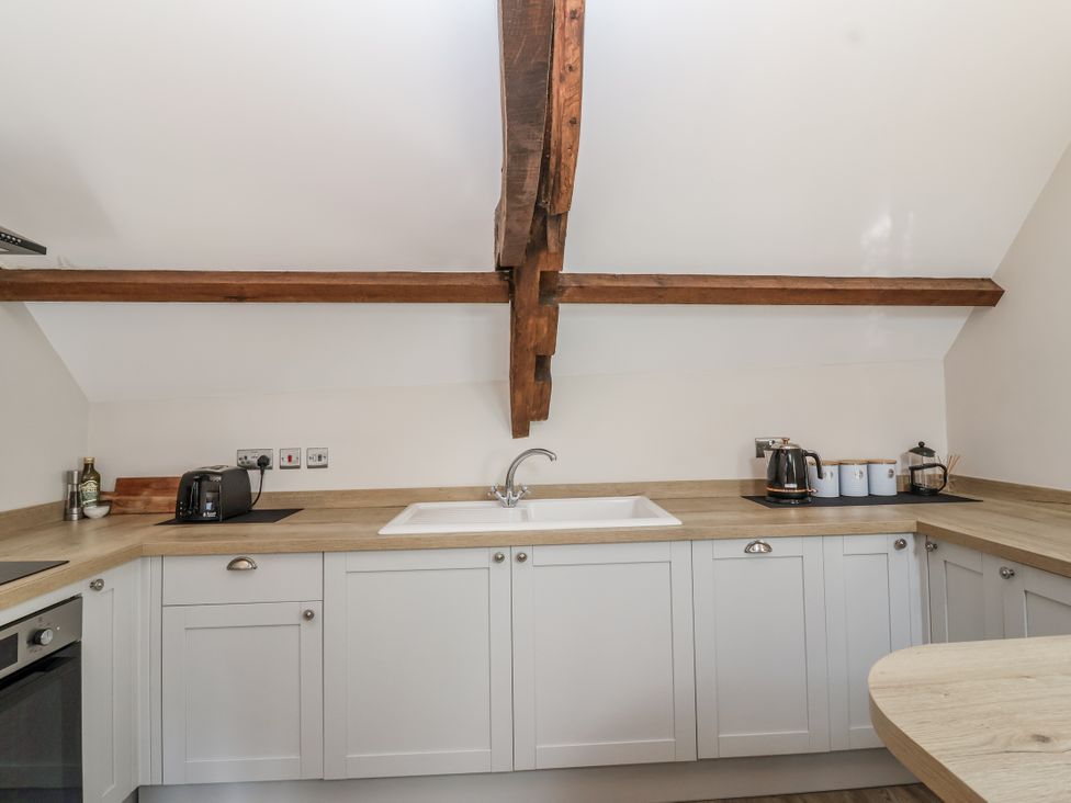 A kitchen with a sink and appliances at The Old Dairy in Acton Turville near Nettleton