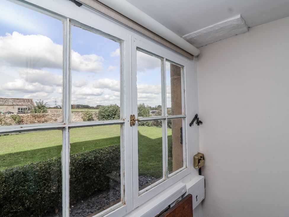 A view from a window showing grass and clouds at The Old Dairy Acton Turville near Nettleton
