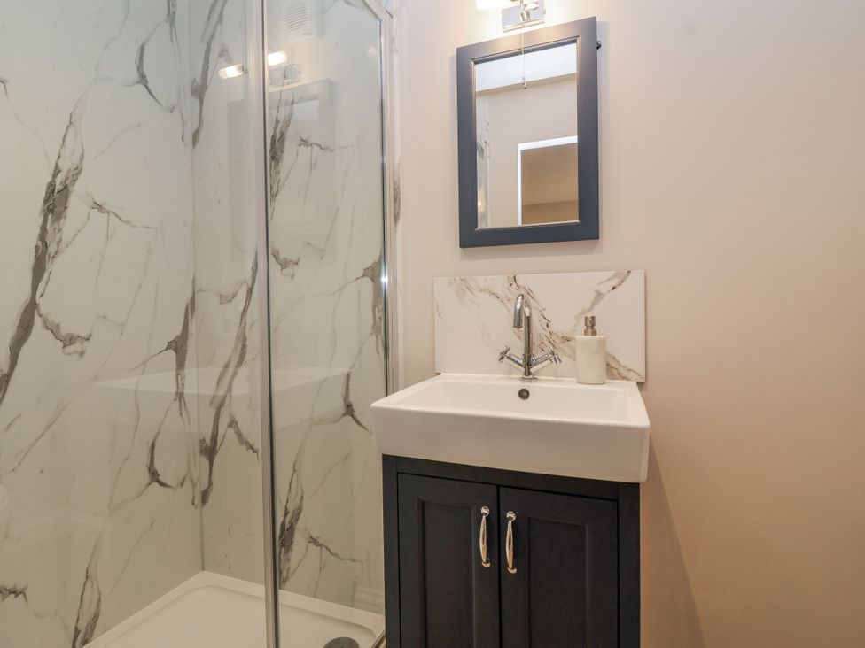 A bathroom with shower and sink at The Old Dairy in Acton Turville near Nettleton