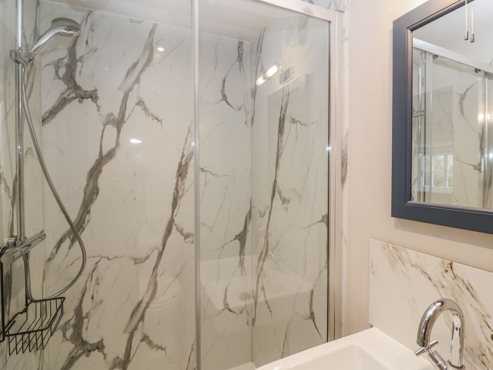 A bathroom with a shower and sink at The Old Dairy in Acton Turville near Nettleton
