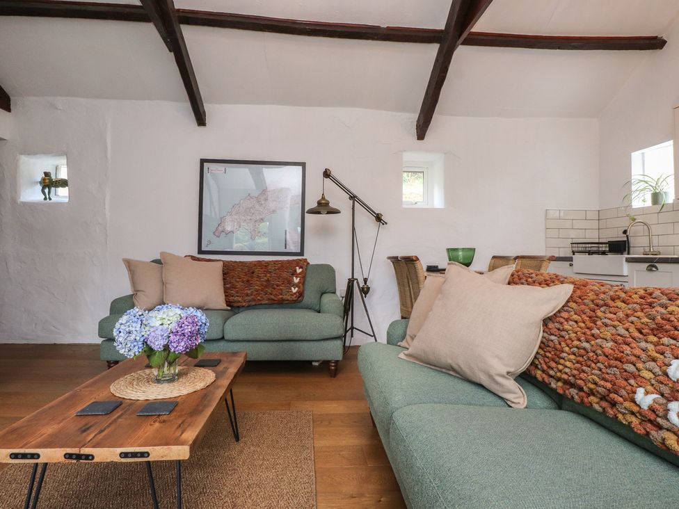 A living room with a sofa and coffee table at Garreg Fawr