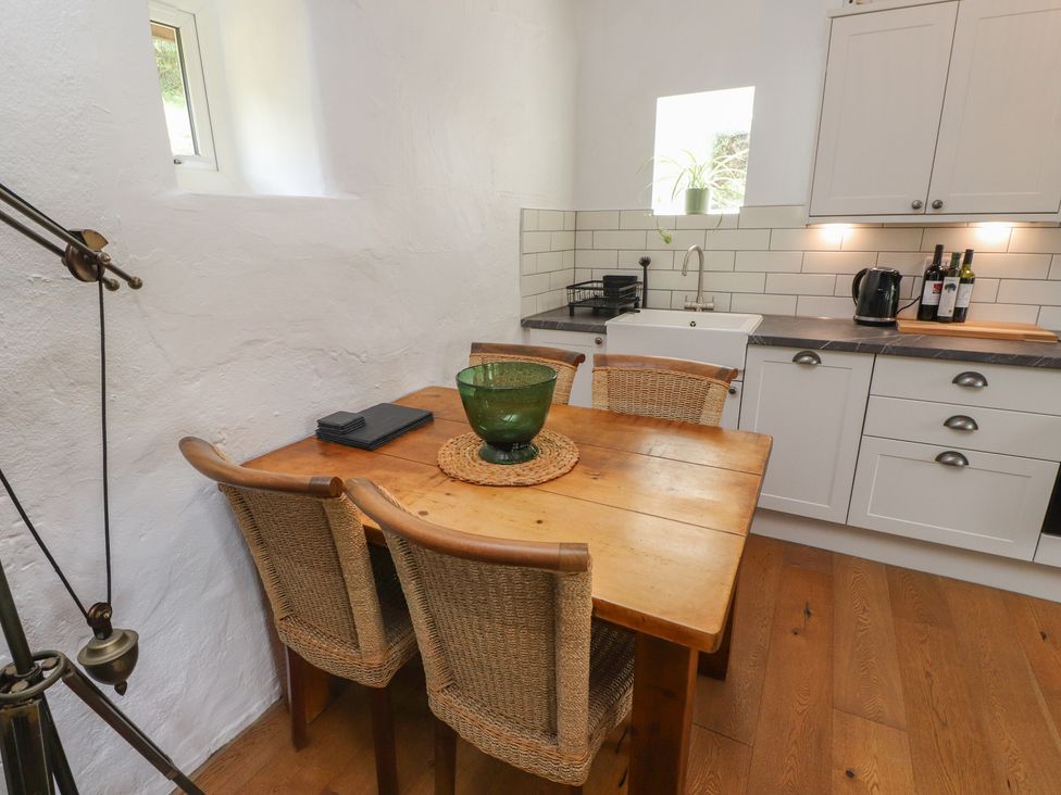 A kitchen with a dining table and chairs at Garreg Fawr