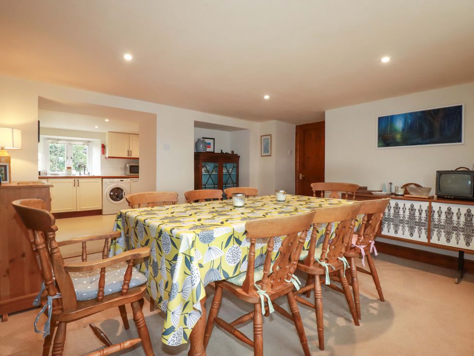A dining room with a table and chairs at Rosewin Farmhouse near St Minver