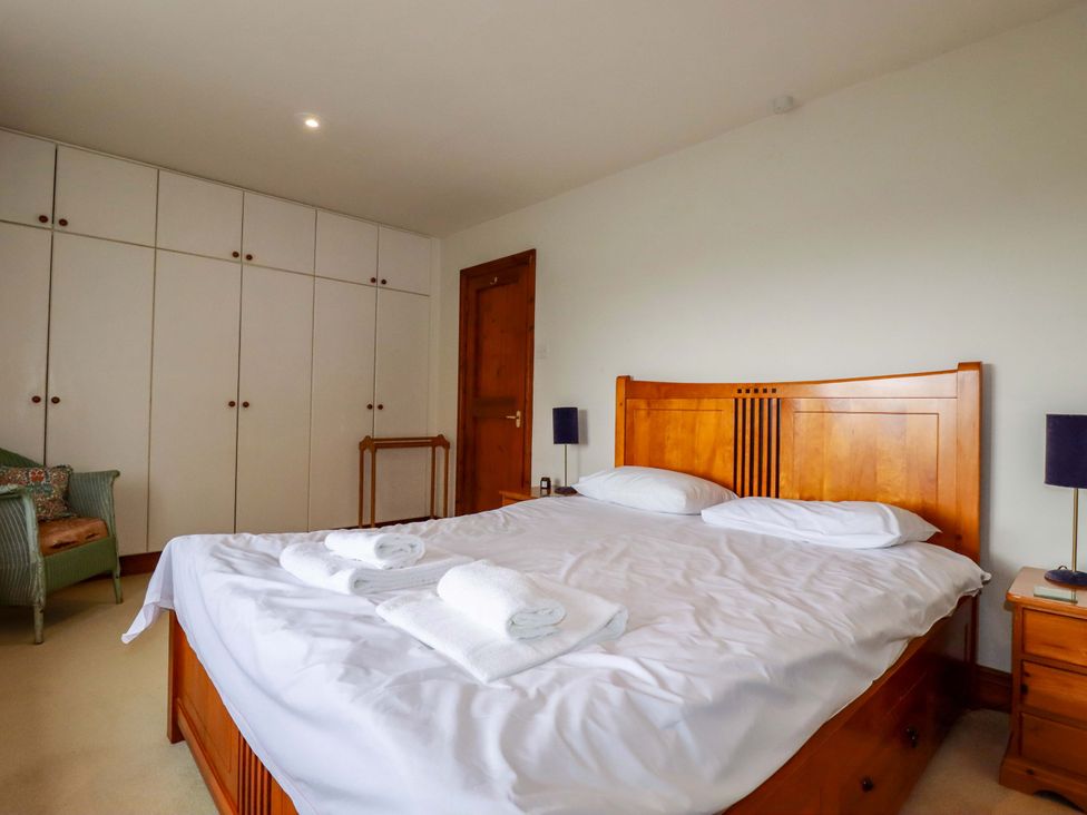 A bedroom with a bed and wardrobe at Rosewin Farmhouse near St Minver