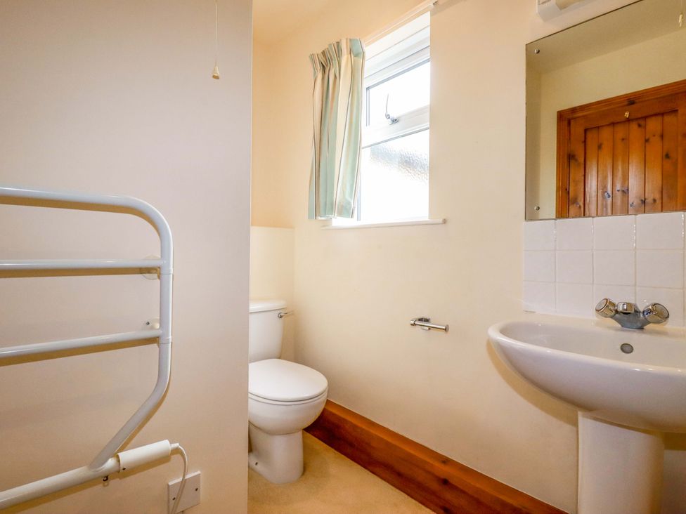 A bathroom with a toilet and sink at Rosewin Farmhouse near St Minver