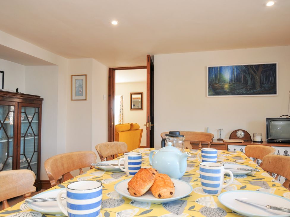 A dining room with a table set for breakfast at Rosewin Farmhouse near St Minver