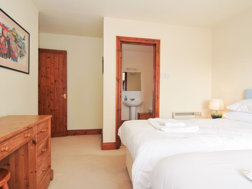 A bedroom with two beds and a washbasin at Rosewin Farmhouse near St Minver