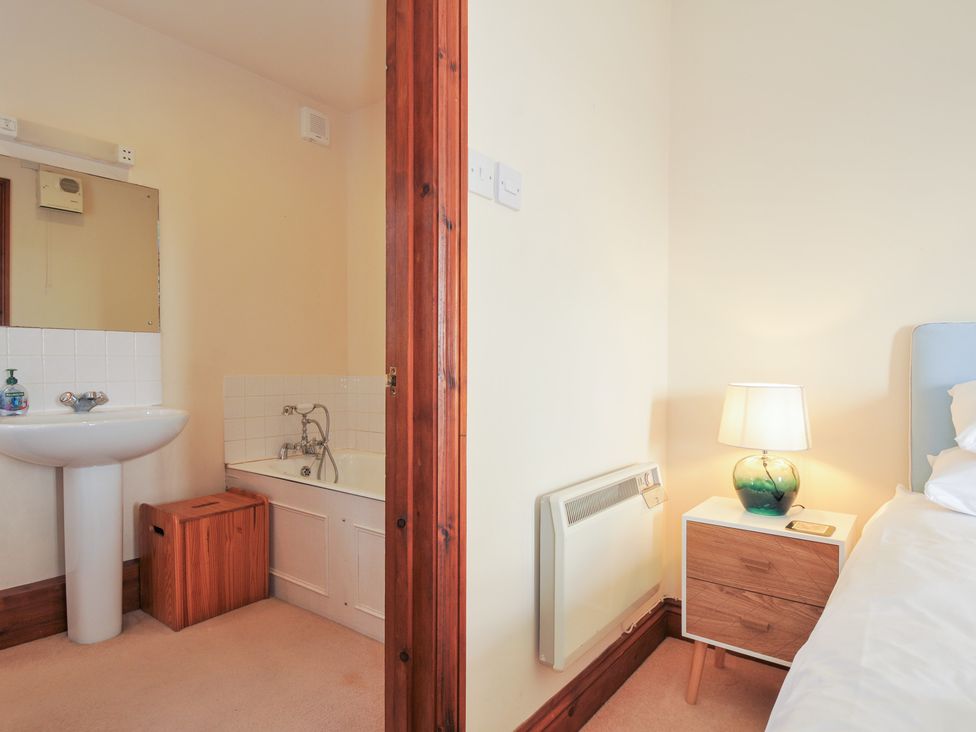 A bathroom with a wash basin and bath at Rosewin Farmhouse near St Minver