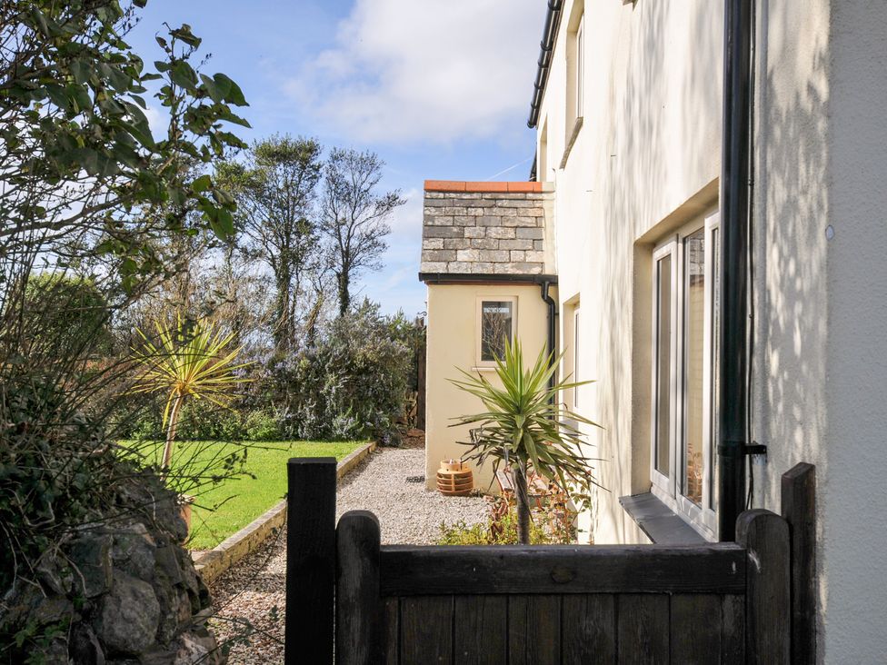 An exterior view of a house with plants and gravel at Rosewin Farmhouse near St Minver