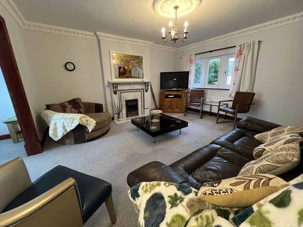 A living room with a fireplace and sofa at The Peak View Holmfirth