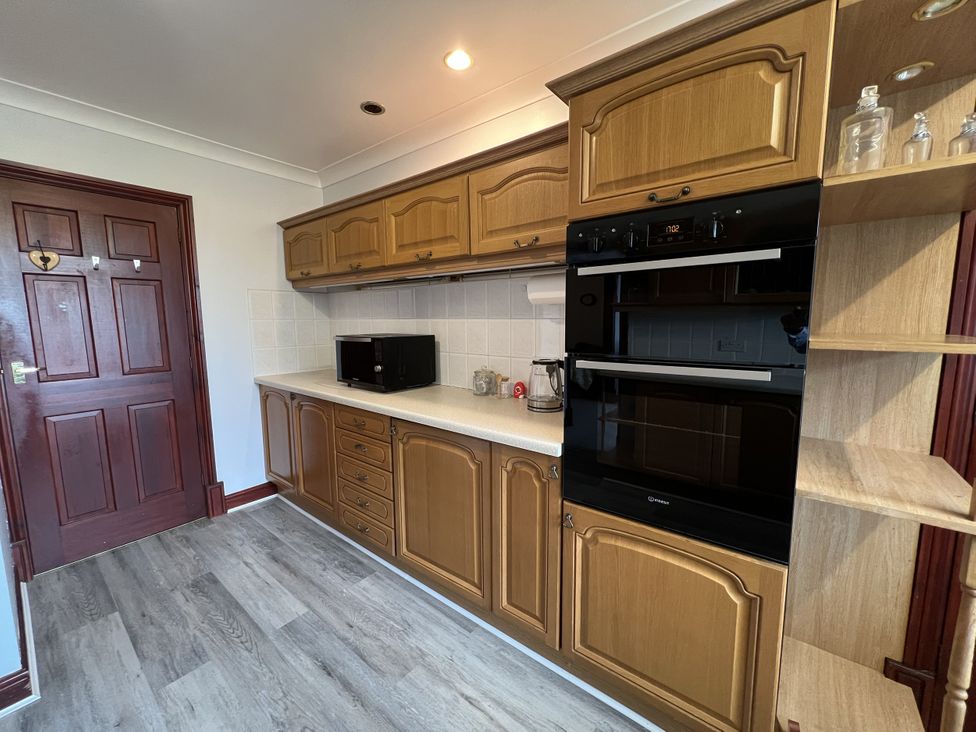 A kitchen with cabinets microwave and oven at The Peak View Holmfirth