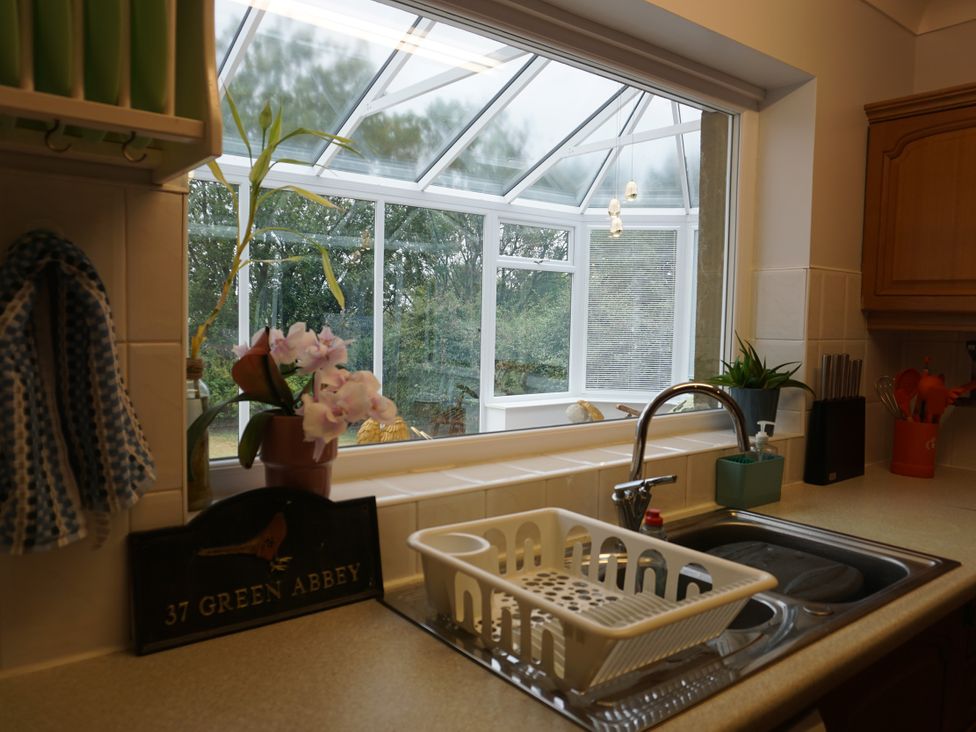 A kitchen with a sink and dish rack at The Peak View Holmfirth