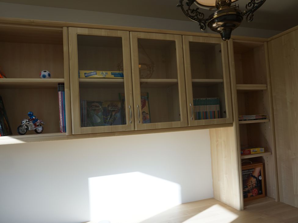 An office with a cabinet containing books and toys at The Peak View Holmfirth