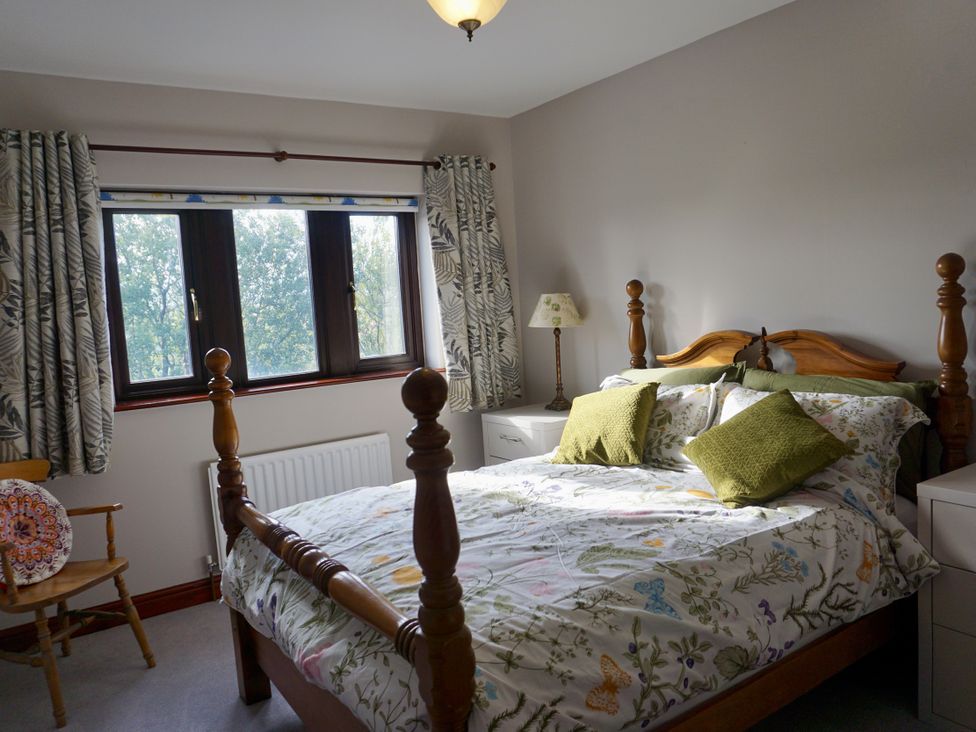 A bedroom with a bed and window at The Peak View Holmfirth
