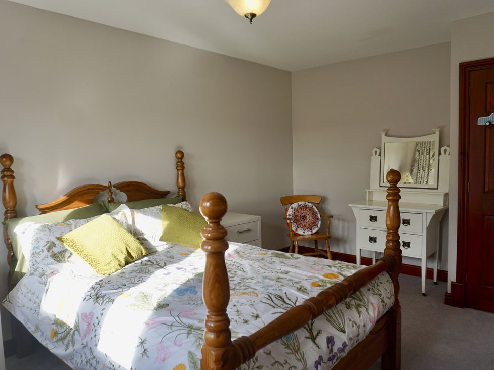 A bedroom with a bed and a dresser at The Peak View Holmfirth