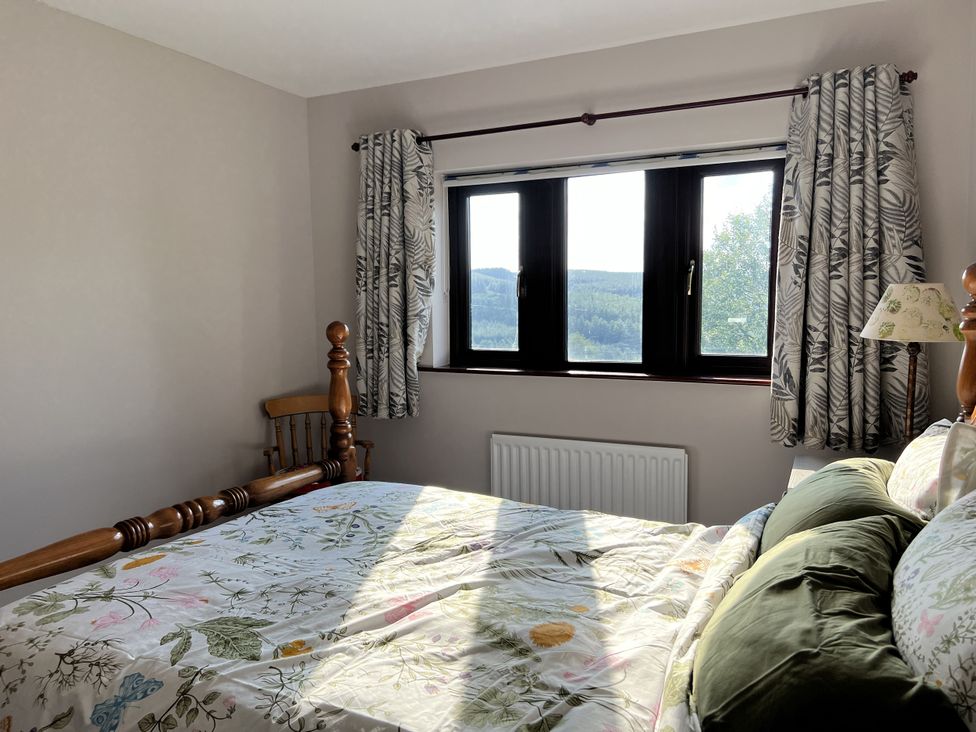 A bedroom with a bed and window at The Peak View Holmfirth