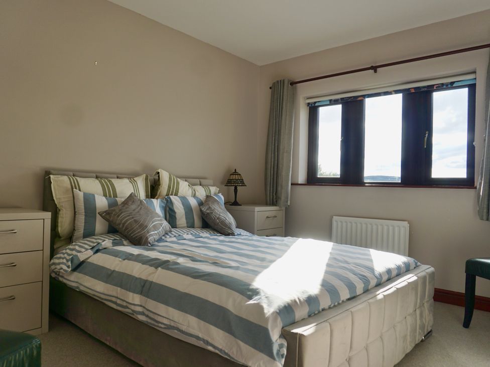 A bedroom with a bed and bedside table at The Peak View Holmfirth