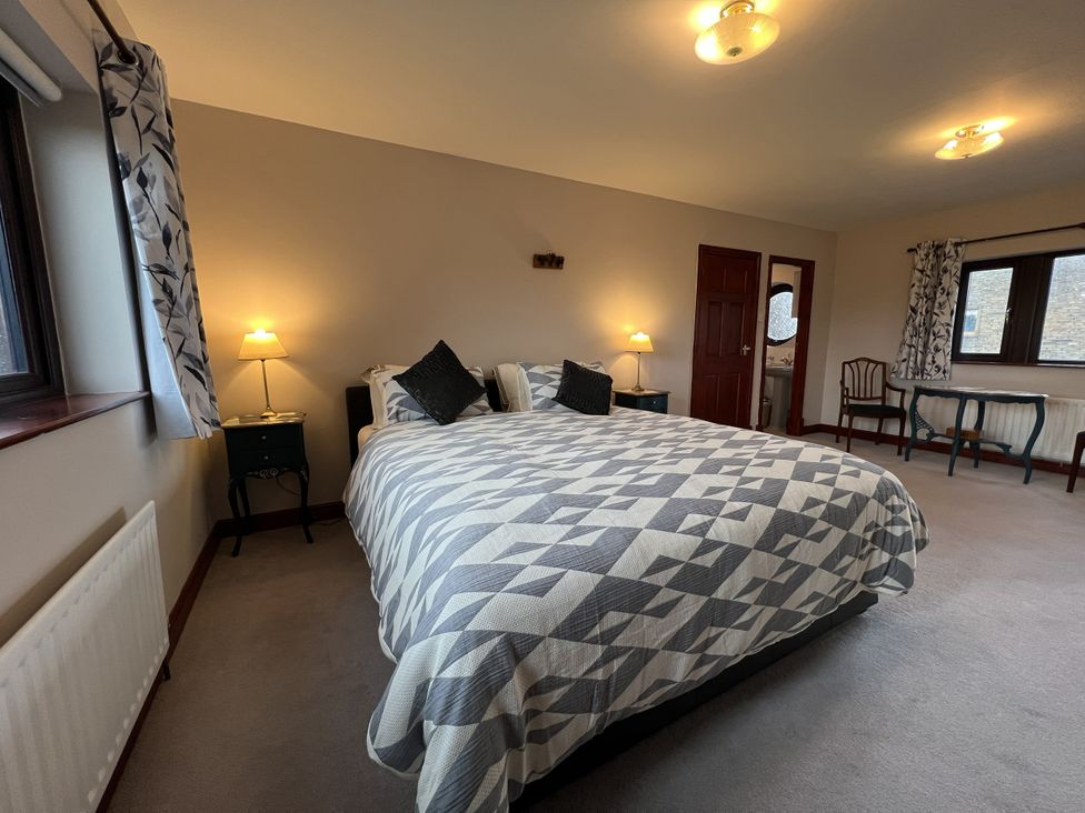 A bedroom with a bed and lamps at The Peak View Holmfirth