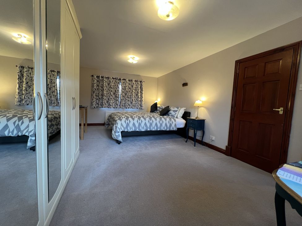A bedroom with a bed and a wardrobe at The Peak View Holmfirth