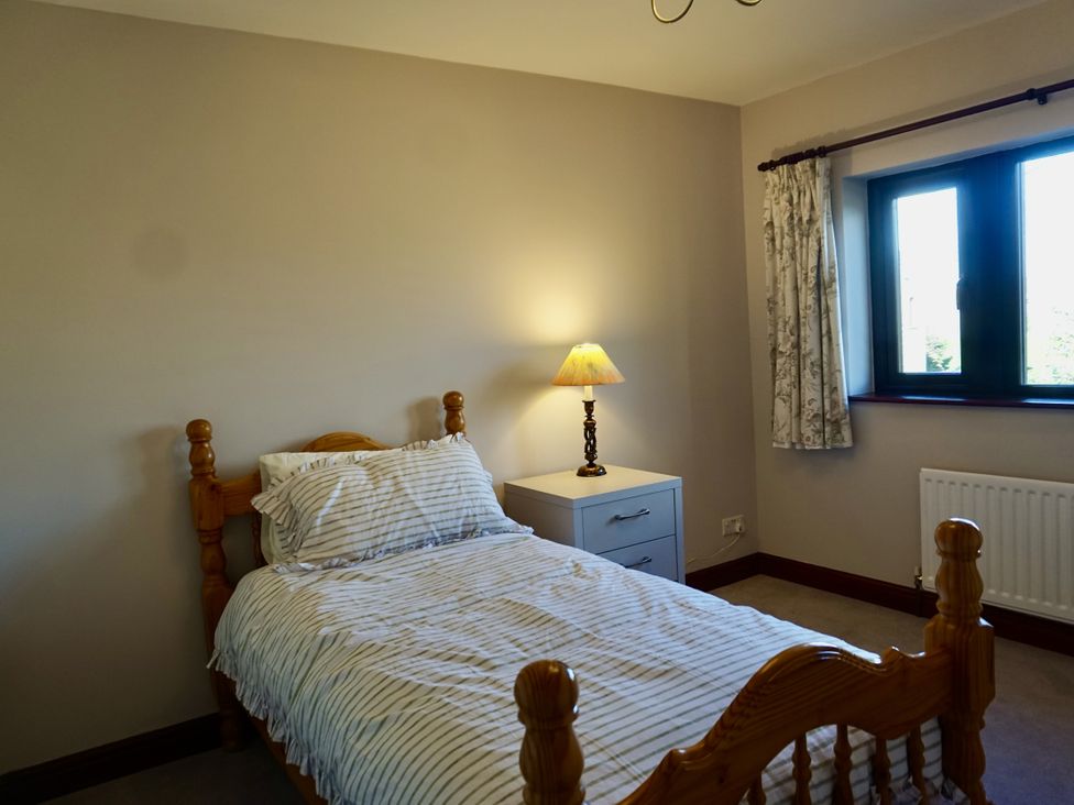 A bedroom with a single bed and a nightstand at The Peak View Holmfirth