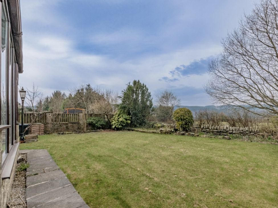 A garden with grass and trees at The Peak View Holmfirth