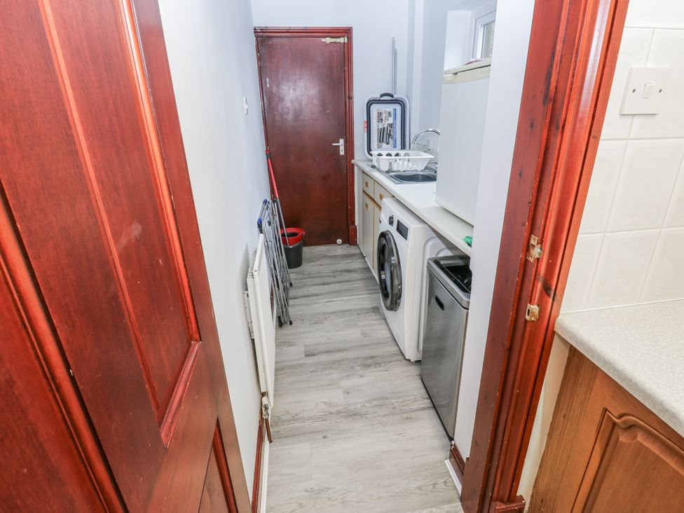 A laundry room with appliances and storage at The Peak View Holmfirth