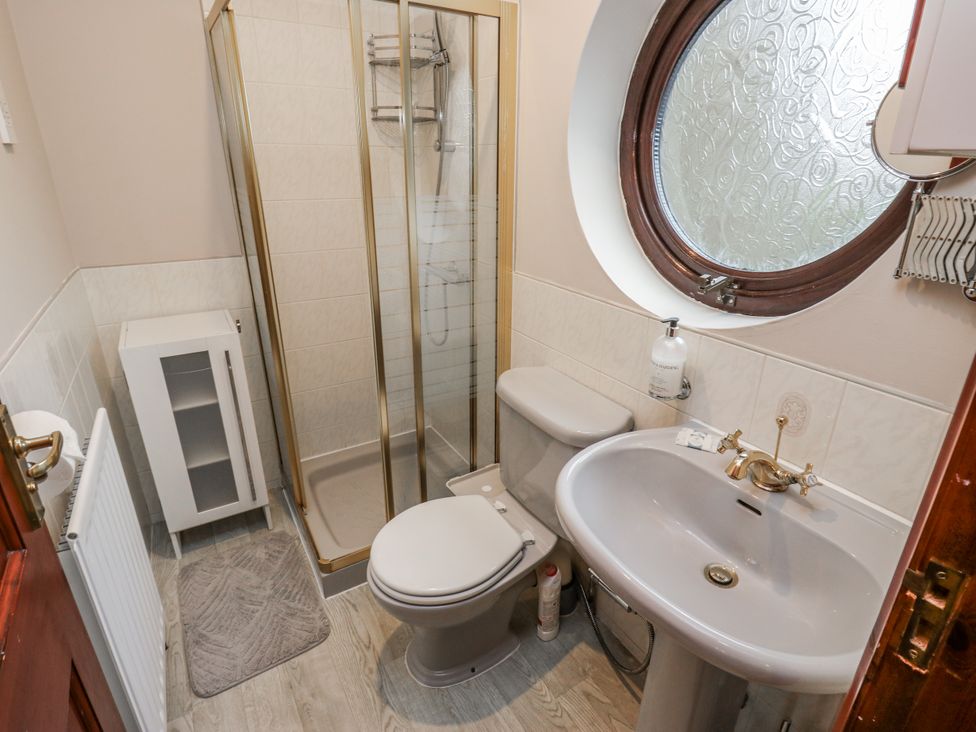 A bathroom with a shower, toilet, and sink at The Peak View Holmfirth